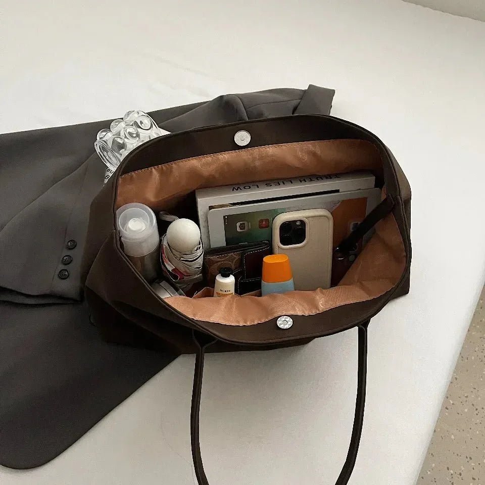 Large black vegan suede handbag for women, open to show organized spacious interior with daily essentials