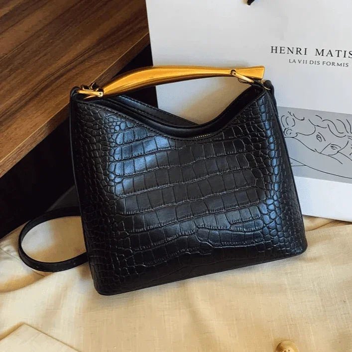 Elegant black crocodile pattern handbag for women with gold top handle and crossbody strap