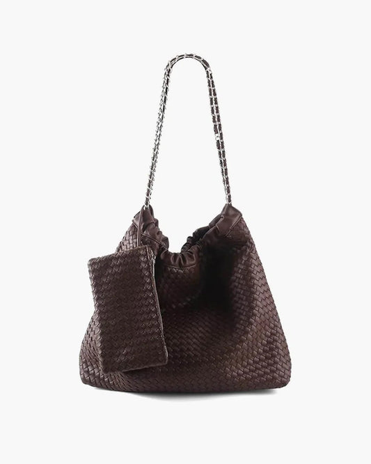 Woven brown leather shoulder bag with drawstring top and matching pouch on white background