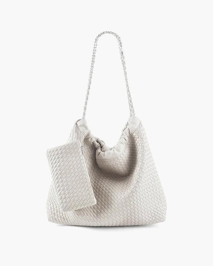 White woven shoulder bag with chain strap and matching pouch on white background