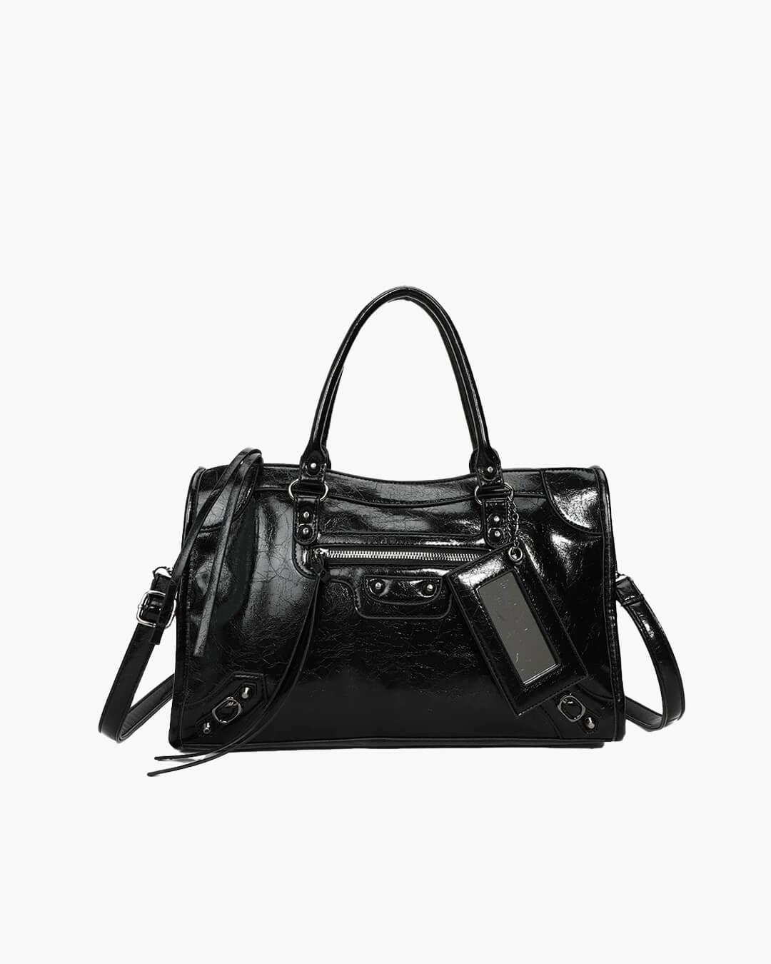 Black minimalist handbag with spacious interior, dual handles, and detachable shoulder strap
