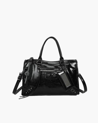 Black minimalist handbag with spacious interior, dual handles, and detachable shoulder strap