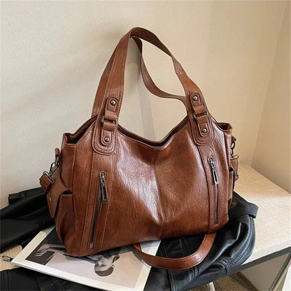 Brown shoulder bag for women with zipper pockets and spacious design on a table