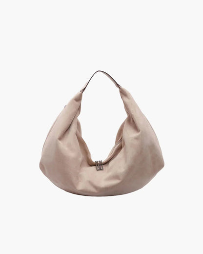 Beige suede hobo handbag with zipper, large capacity, single shoulder strap, on white background.